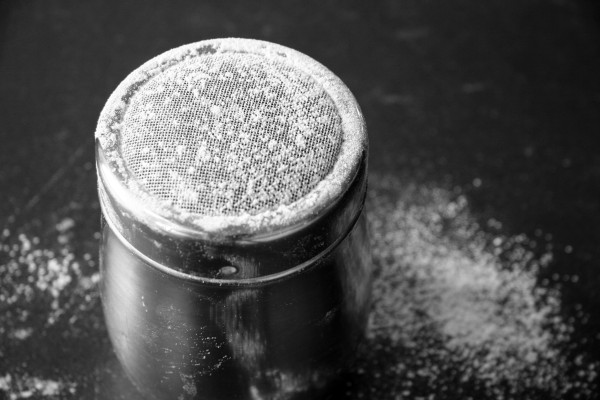 grilled pizza crusts - flour shaker