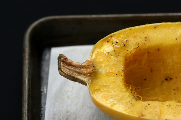spaghetti squash with parmesan and fresh herbs - on pan